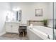 Well-lit bathroom with a soaking tub, vanity area, and decorative accents at 16 Franklin S Ct # A, St Petersburg, FL 33711