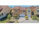 Charming home featuring a two-car garage, a red tile roof, and well manicured landscaping at 16 Franklin S Ct # A, St Petersburg, FL 33711