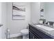 Contemporary half-bath with granite countertop and elegant decor at 16 Franklin S Ct # A, St Petersburg, FL 33711