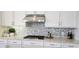 Bright kitchen with white cabinetry, stainless steel appliances, and stylish backsplash at 16 Franklin S Ct # A, St Petersburg, FL 33711