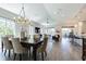 Open-concept living and dining area with wood-look tile and lots of natural light at 16 Franklin S Ct # A, St Petersburg, FL 33711