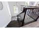 Dark wood staircase with metal railing and modern design for a sophisticated entry at 16 Franklin S Ct # A, St Petersburg, FL 33711