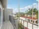 Balcony featuring black iron railing and views of the neighborhood with trees and buildings at 170 E Davis Blvd, Tampa, FL 33606