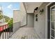 Wide angle of balcony featuring weathered wood flooring, railing, and gray stucco exterior at 170 E Davis Blvd, Tampa, FL 33606