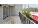 Balcony with wood flooring and black metal railing with views of neighborhood street at 170 E Davis Blvd, Tampa, FL 33606