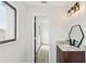 Bright bathroom showcasing a dark vanity with granite countertops and a stylish mirror at 170 E Davis Blvd, Tampa, FL 33606