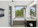 Bright bathroom with a window over the tub, modern vanity, and stylish mirror at 170 E Davis Blvd, Tampa, FL 33606