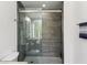Modern bathroom featuring a glass door shower with gray tiled walls and hexagonal tile flooring at 170 E Davis Blvd, Tampa, FL 33606
