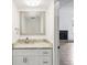 Stylish half-bathroom featuring modern vanity, granite countertop, and a decorative mirror at 170 E Davis Blvd, Tampa, FL 33606
