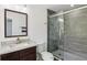 Bathroom featuring a glass-enclosed shower, granite counters and a wood vanity at 170 E Davis Blvd, Tampa, FL 33606