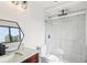 Modern bathroom featuring a glass-enclosed shower, a dark framed mirror, and granite countertops at 170 E Davis Blvd, Tampa, FL 33606