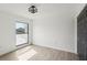 Bright bedroom featuring wood-look tile flooring, closet, and a large window at 170 E Davis Blvd, Tampa, FL 33606