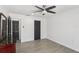 Bright bedroom with a ceiling fan and modern gray wood-look tile flooring at 170 E Davis Blvd, Tampa, FL 33606