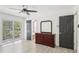 Spacious bedroom featuring wood-look tile flooring, ceiling fan, and a balcony at 170 E Davis Blvd, Tampa, FL 33606