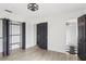 Bedroom features wood-look tile flooring, closet, and an open bathroom with a glass enclosed shower at 170 E Davis Blvd, Tampa, FL 33606