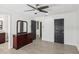 Bright bedroom with wood-look floors, ceiling fan, and matching dresser at 170 E Davis Blvd, Tampa, FL 33606
