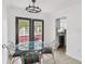 Bright dining space with a glass table and chairs, complemented by a view of the kitchen and outdoors at 170 E Davis Blvd, Tampa, FL 33606