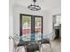 Dining room with modern lighting, adjacent to the kitchen and features a glass table at 170 E Davis Blvd, Tampa, FL 33606