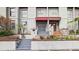 Multi-level townhome with a red awning over the entryway and well-maintained landscaping at 170 E Davis Blvd, Tampa, FL 33606
