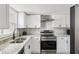 Modern kitchen featuring granite countertops, stainless steel appliances, and sleek white cabinets at 170 E Davis Blvd, Tampa, FL 33606