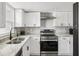 Bright kitchen with stainless steel appliances, white cabinets, and luxury vinyl flooring at 170 E Davis Blvd, Tampa, FL 33606