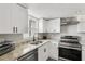 Well-lit kitchen boasting stainless steel appliances, white cabinetry, and modern fixtures at 170 E Davis Blvd, Tampa, FL 33606