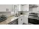 Bright kitchen featuring stainless steel appliances, white cabinets and granite countertops at 170 E Davis Blvd, Tampa, FL 33606