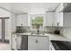 Bright kitchen featuring stainless steel appliances, white cabinets and granite countertops at 170 E Davis Blvd, Tampa, FL 33606