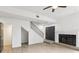 Open living room with a ceiling fan, fireplace, staircase and hardwood floors at 170 E Davis Blvd, Tampa, FL 33606