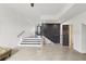 Open-concept living space featuring modern stairs, black accent wall, and ample natural light at 170 E Davis Blvd, Tampa, FL 33606