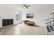 Living room featuring a fireplace and stairs with a large picture window adding natural light at 170 E Davis Blvd, Tampa, FL 33606