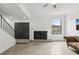 Spacious living room with a fireplace and stairs, complete with light, wood-look tile flooring at 170 E Davis Blvd, Tampa, FL 33606