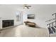Bright living room features a fireplace, ceiling fan and luxury vinyl flooring at 170 E Davis Blvd, Tampa, FL 33606
