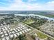Aerial view capturing the mobile home's location near a lake, amidst green vegetation, showcasing the tranquil environment at 1710 7Th Sw St # 95, Ruskin, FL 33570