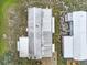 Birds-eye view of a mobile home with a metal roof, located in a grassy area near another similar home at 1710 7Th Sw St # 95, Ruskin, FL 33570