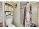 The bathroom showcases a tiled shower, toilet, storage, and a decorative shower curtain at 1710 7Th Sw St # 95, Ruskin, FL 33570