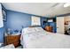 Bedroom featuring bright blue walls, wooden furnishings, and natural lighting at 1710 7Th Sw St # 95, Ruskin, FL 33570