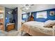 Well-lit bedroom featuring blue walls, a closet, and wooden furnishings at 1710 7Th Sw St # 95, Ruskin, FL 33570