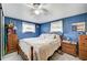 Bright bedroom featuring a decorative bedspread, wood furnishings, and natural light at 1710 7Th Sw St # 95, Ruskin, FL 33570
