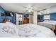 Bedroom featuring blue walls, closet, ceiling fan, and wooden furnishings at 1710 7Th Sw St # 95, Ruskin, FL 33570