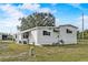 Exterior showcases white siding, dark shutters, and a well-maintained yard at 1710 7Th Sw St # 95, Ruskin, FL 33570