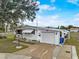 Street-level exterior view with a garage, easy access to paved driveway, and landscaping at 1710 7Th Sw St # 95, Ruskin, FL 33570