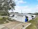 Exterior showcasing attached garage, well-maintained lawn, and neutral siding at 1710 7Th Sw St # 95, Ruskin, FL 33570