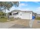 Charming single-story home with a garage and well-kept lawn, showcasing curb appeal at 1710 7Th Sw St # 95, Ruskin, FL 33570