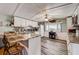 Bright kitchen featuring white cabinets, stylish countertops, modern appliances, and bar stool seating at 1710 7Th Sw St # 95, Ruskin, FL 33570