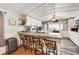 Kitchen and breakfast bar featuring updated countertop, cabinetry, and wood flooring at 1710 7Th Sw St # 95, Ruskin, FL 33570