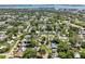 Expansive aerial view of a residential neighborhood showcasing tree-lined streets, homes, and the nearby ocean at 1808 Gray S St, Gulfport, FL 33707