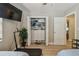 Bedroom features a closet with custom shelving, wood laminate flooring, and a wall-mounted television at 1808 Gray S St, Gulfport, FL 33707