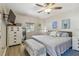 Comfortable main bedroom features a ceiling fan, neutral walls, light-colored wood floors and coastal-themed decor at 1808 Gray S St, Gulfport, FL 33707