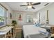 Bedroom with changing table, crib and queen bed featuring nautical accents, and wood laminate flooring at 1808 Gray S St, Gulfport, FL 33707